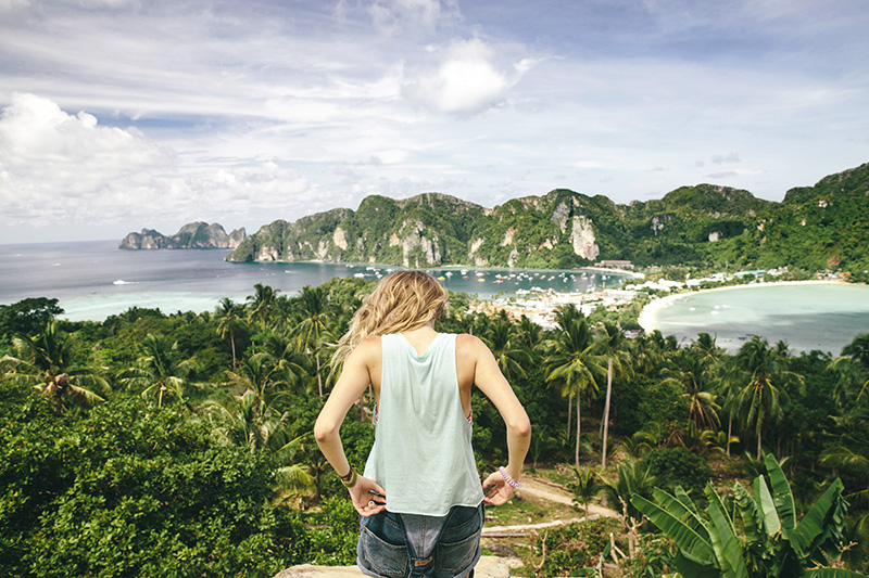 Back view of female eco-tourist against of beautiful scene of Phi-Phi island panorama in Krabi, Thailand