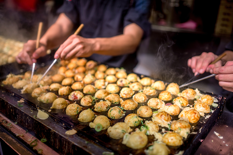 Takoyaki cooking in Amerikamura, Osaka, Japan