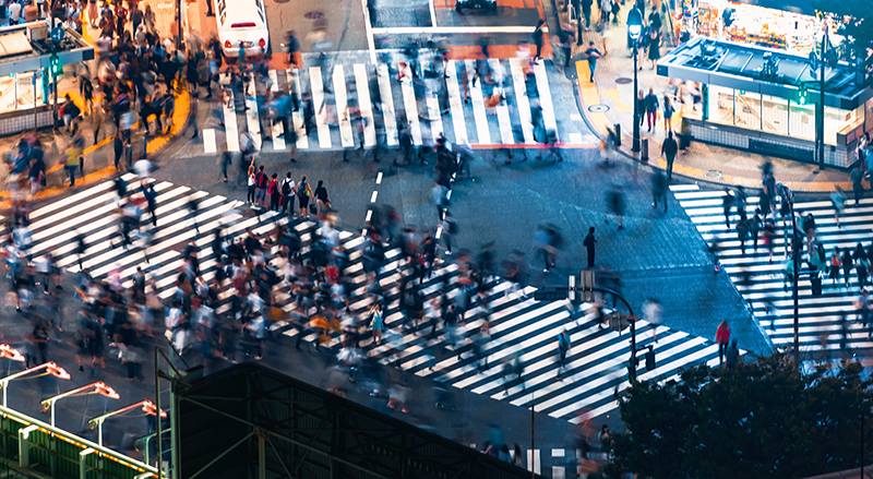 Pedestrians cross the Shibuya Scramble crosswalk in Tokyo, Japan,